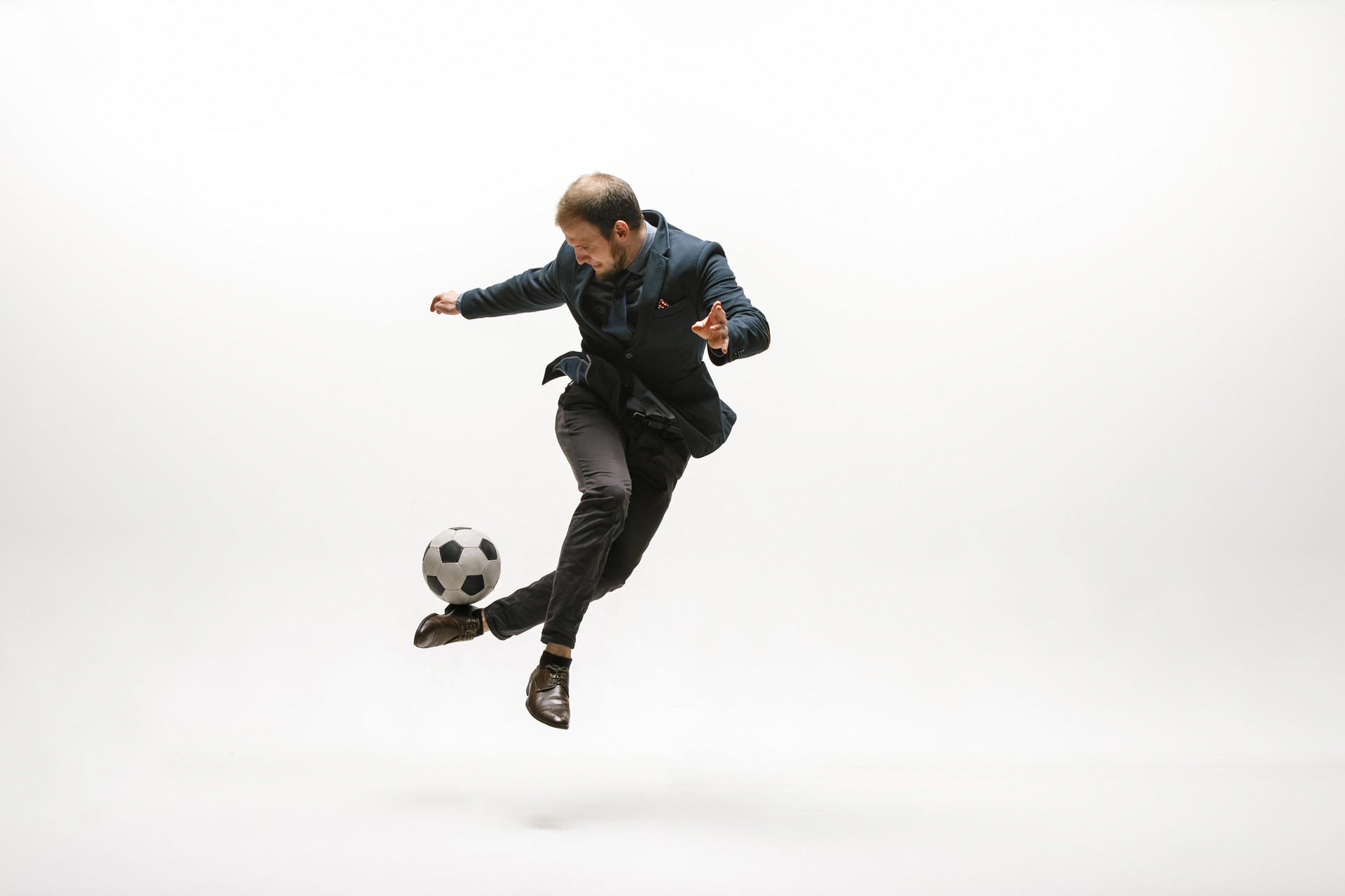 Businessman with football ball in office